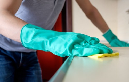 Technician wearing PPE while cleaning carpet safely